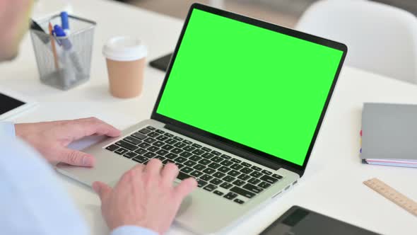 Middle Aged Man Using Laptop with Chroma Screen 