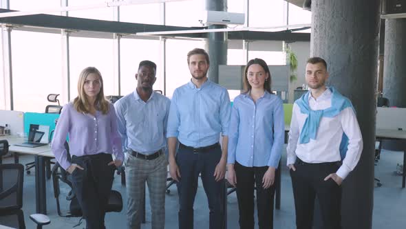 Group of Businesspeople Standing Together in Office