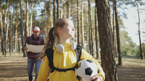 Happy Family Hiking Through a Forest