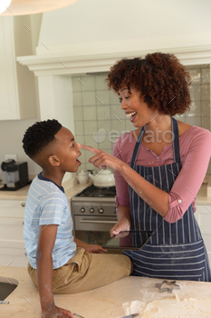Happy african american mother with son baking in kitchen, having fun and using tablet / Photodune, Misc
