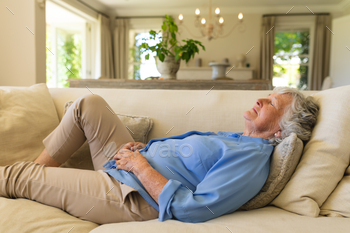 Senior caucasian woman lying on sofa with eyes closed / Photodune, Misc