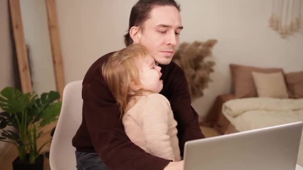 A Man Works at His Laptop at Home