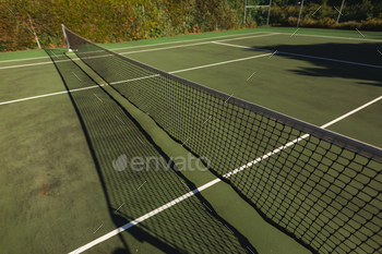 General view of tennis court and tennis net on sunny day / Photodune, Misc