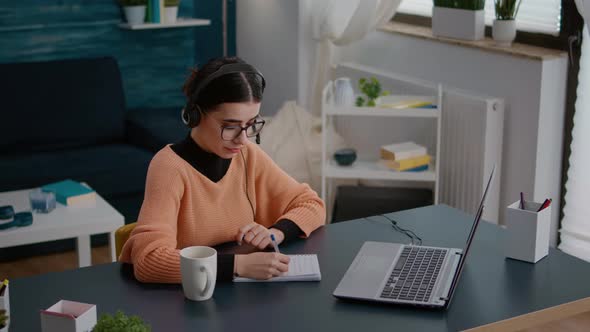 University Student Listening to Online School Class on Laptop alt
