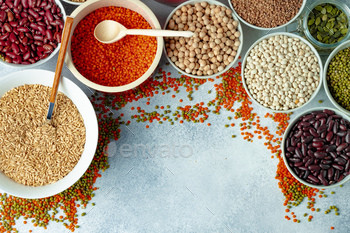 Top view of ceramic bowls with assorted grains on wooden table / Photodune, Misc