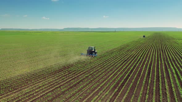 Tractor Cultivating Field At Spring, Aerial View.