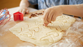 Closeup of little boy filling biscuit dough with raisins and nuts - PhotoDune Item for Sale