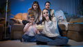Group of people eating popcorn while watching movie or TV show in living room at night - PhotoDune Item for Sale