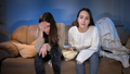 Two young girls watching football match on TV and getting upset after team losing or missing goal - PhotoDune Item for Sale