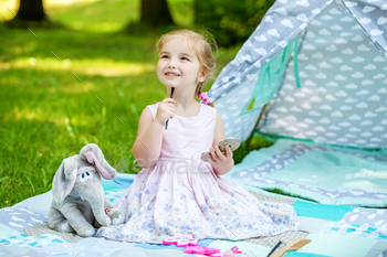 A small child is playing with cosmetics. Curler. The concept of / Photodune, Misc