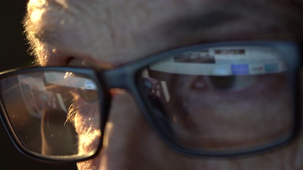 Closeup of the Focused Eyes of a Businessman Wearing Computer Glasses