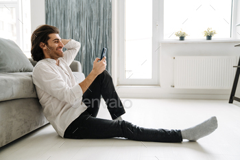 Smiling mid aged turkish man holding mobile phone / Photodune, Misc