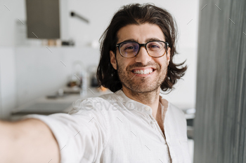 Smiling mid aged turkish man taking selfie / Photodune, Misc
