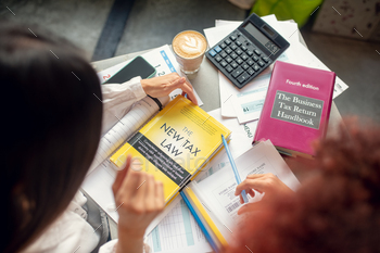 Close up of women studying tax return after launching business / Photodune, Misc