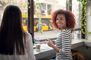 Cheerful entrepreneur smiling while working with friend / Photodune, Misc