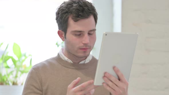 Portrait of Video Call on Tablet By Man in Office