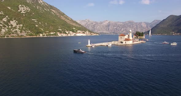 Motor Boat Sails Across the Sea Past the Island of Gospa Od Skrpjela