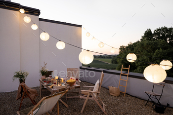 Beautifully decorated roof terrace with a dining table / Photodune, Misc