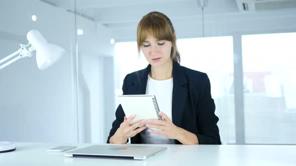 Young Businesswoman Reading Office Documents at Work