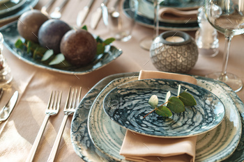 Beautiful elegant table setting with green stylish dishware and silver cutlery / Photodune, Misc