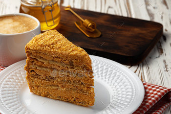Slice of layered honey cake on plate / Photodune, Misc