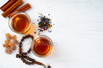 Cup of tea with cinnamon sticks on table / Photodune, Misc