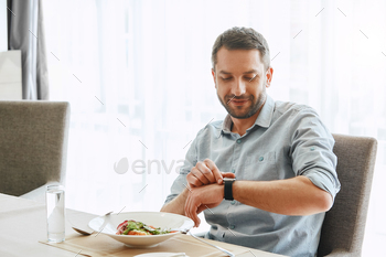 Eat Right and Light. Smiling handsome businessman eating salad / Photodune, Misc