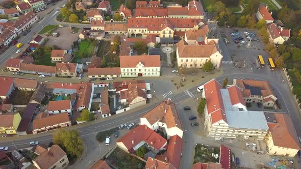 Aerial view of small old european town with red tiled roofs of small houses and narrow streets.