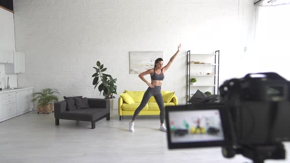 Young Beautiful Woman Performs Exercises on the Camera