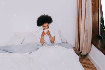 Afro american girl in bed at home / Photodune, Misc