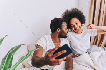 Afro american couple in bed at home / Photodune, Misc