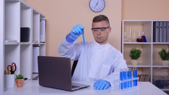 Young Scientist Works with Test Tubes