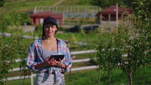 Smiling Woman Farmer in the Garden