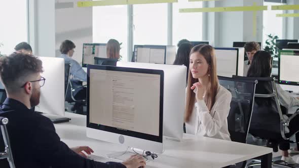 Modern Open Space Corporate Office with Tow Rows Off Businessmen and Businesswomen Working on