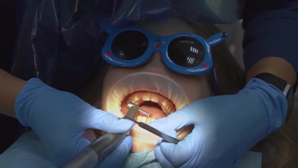 Little Girl with Oral Dilator at Dentist's Appointment