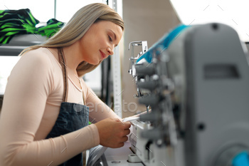 Beautiful female seamstress working with fabric at her workplace / Photodune, Misc