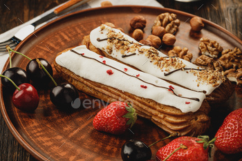 Two eclairs decorated with berries and nuts / Photodune, Misc