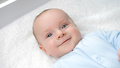 Portrait of happy smiling baby boy with blue eyes smiling on dressing table. Concept of hygiene - PhotoDune Item for Sale
