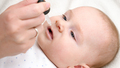 Closeup of little baby boy taking vitamin D from eyedropper. Concept of newborn healthcare and - PhotoDune Item for Sale