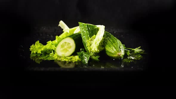 Spraying Cucumbers with Green Lettuce Leaves