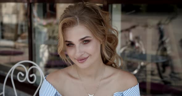 Sexy Girl Sitting In A Cafe On The Summer Terrace