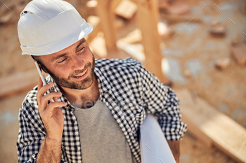 Professional architect making a phone call and holding paper roll / Photodune, Misc