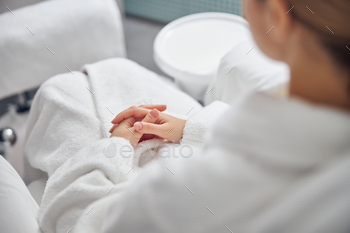 Woman in bathrobe during beauty procedures in salon / Photodune, Misc