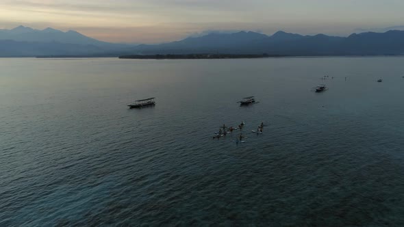 Sunrise Yoga Class on Stand Up Paddle Boards in the Calm Ocean