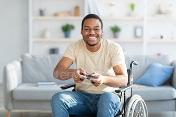 game on playstation, having fun at home. Handicapped male gamer with joystick playing computer arcade. Quarantine hobbies concept