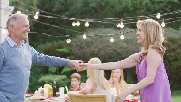 Senior couple dancing outdoors