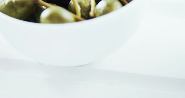 Green olives with stem in a bowl