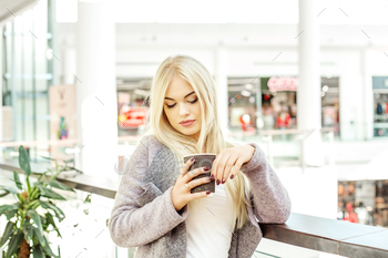 Young blonde girl drinking coffee at the mall. The concept of li / Photodune, Misc
