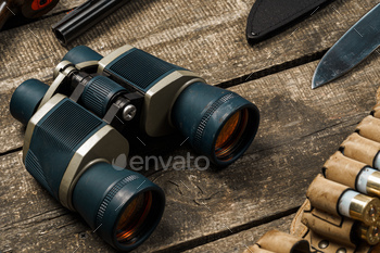 Hunting equipment binoculars on wooden background close up / Photodune, Misc