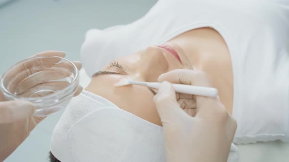 Woman Relaxing on Massage Table During Beauty Procedure